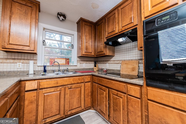 kitchen with tasteful backsplash, sink, a textured ceiling, and black electric stovetop