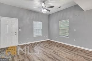 unfurnished room with hardwood / wood-style floors and ceiling fan