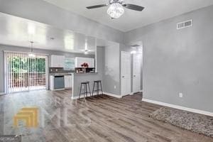 living room with hardwood / wood-style flooring and ceiling fan