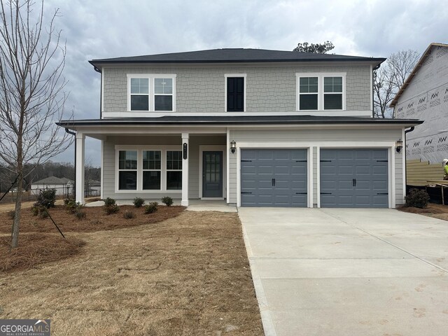 view of front of home featuring a porch and a garage