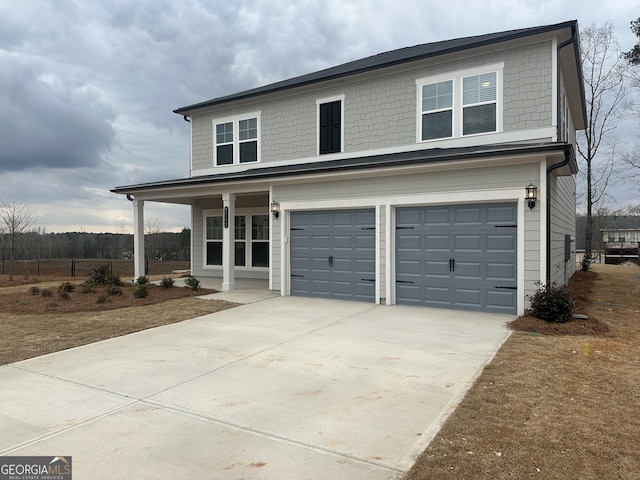 front of property featuring a garage and covered porch