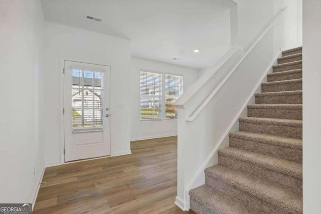 entryway with a healthy amount of sunlight and hardwood / wood-style flooring