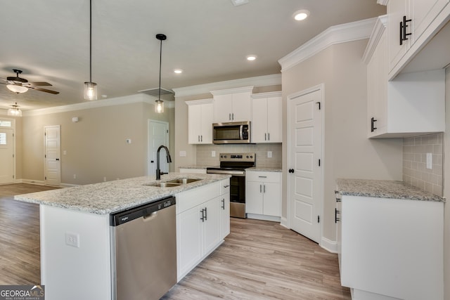 kitchen with a center island with sink, sink, ceiling fan, appliances with stainless steel finishes, and white cabinetry