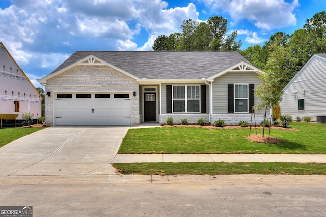 view of front of house featuring central AC unit, a garage, and a front lawn