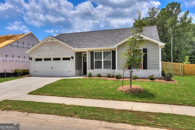 view of front of home featuring a garage and a front lawn