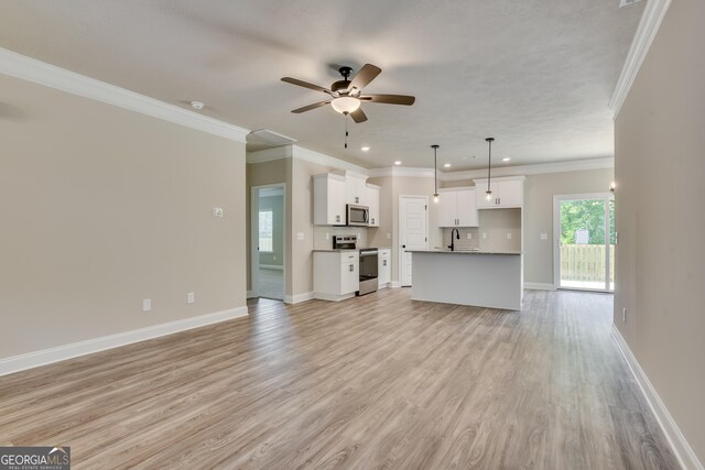 unfurnished living room with light hardwood / wood-style flooring, ceiling fan, ornamental molding, and sink