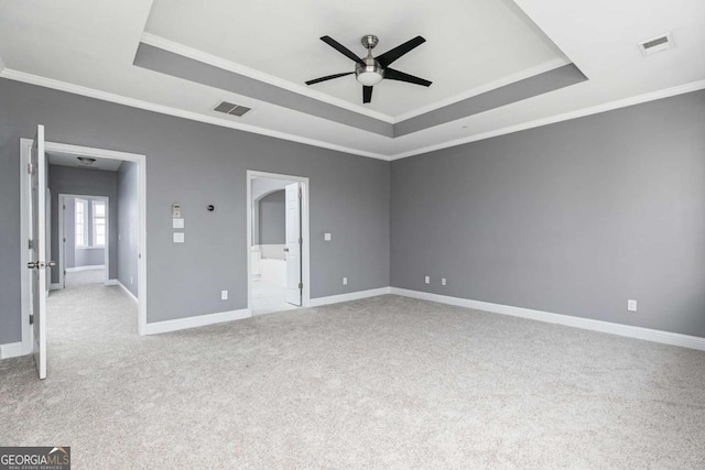 unfurnished bedroom with a raised ceiling, ceiling fan, and ornamental molding