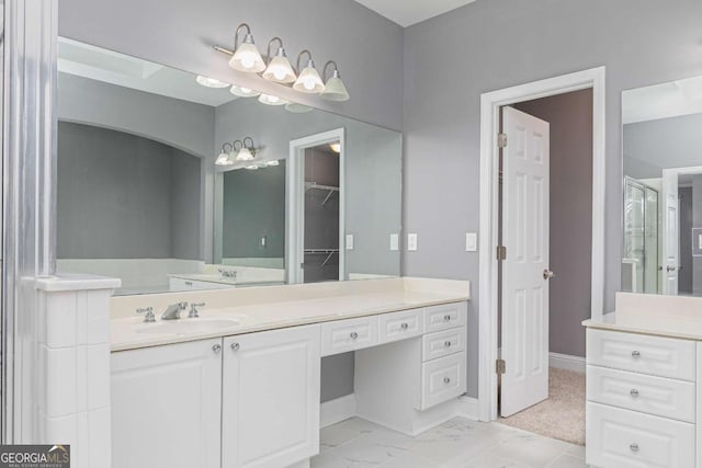 bathroom with vanity and a shower with door