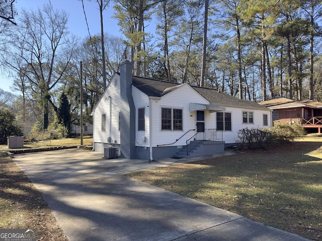 view of front of home with a front lawn and cooling unit