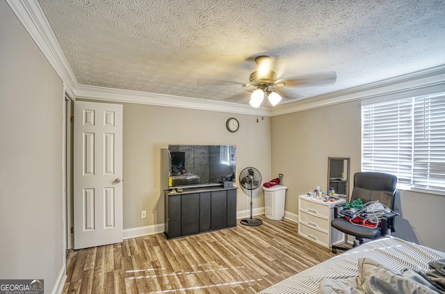 bedroom with ceiling fan, light wood-type flooring, ornamental molding, and a textured ceiling