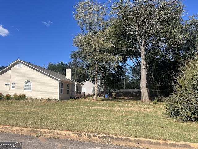 view of side of property with a lawn