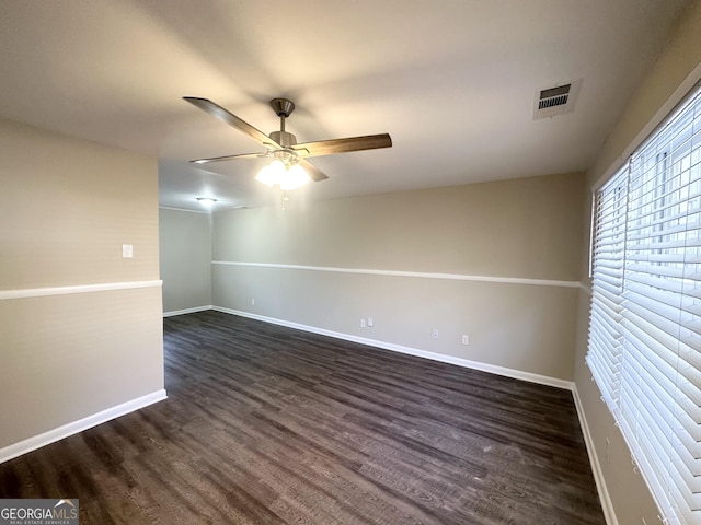 spare room featuring ceiling fan and dark hardwood / wood-style flooring