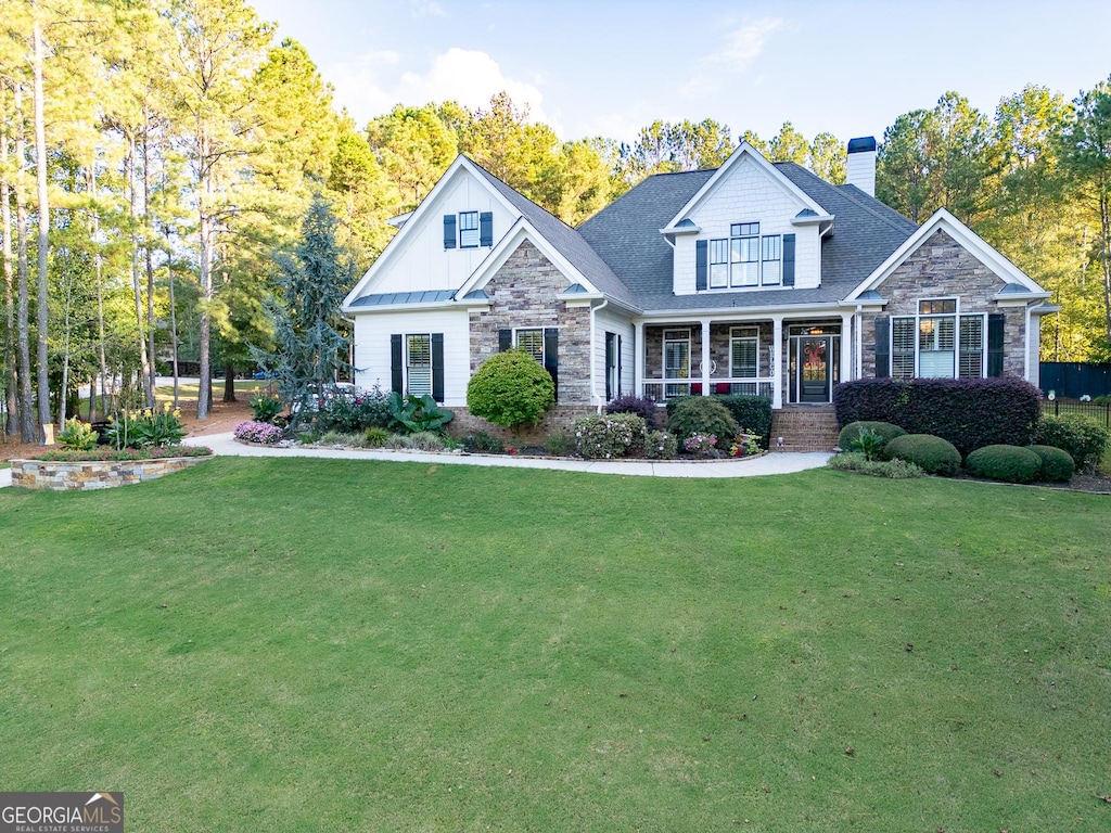 craftsman house with covered porch and a front lawn