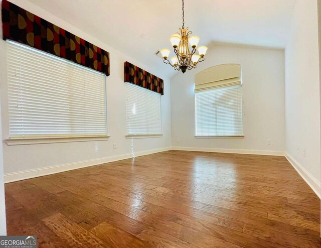 interior space with vaulted ceiling, hardwood / wood-style floors, and a notable chandelier