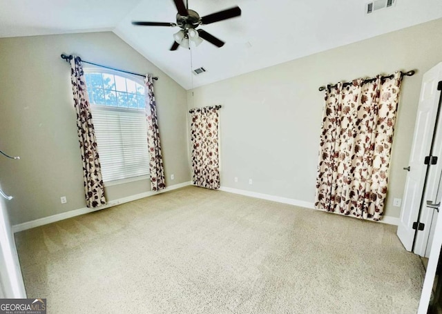 unfurnished bedroom with ceiling fan, lofted ceiling, and carpet flooring