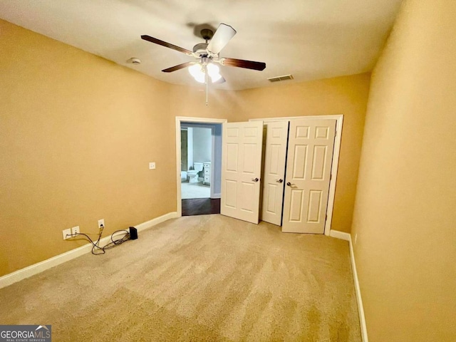 unfurnished bedroom featuring carpet floors, ceiling fan, and a closet