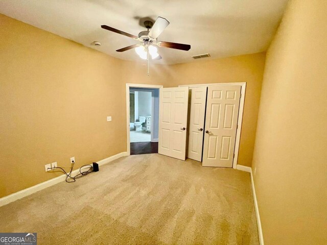 4140 Lanier Ridge Walk Unit 104, Cumming, GA 30041 - unfurnished bedroom with carpet flooring, a closet, and a ceiling fan