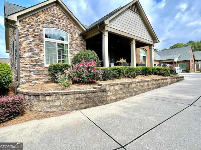 view of front of property with a garage, driveway, and brick siding