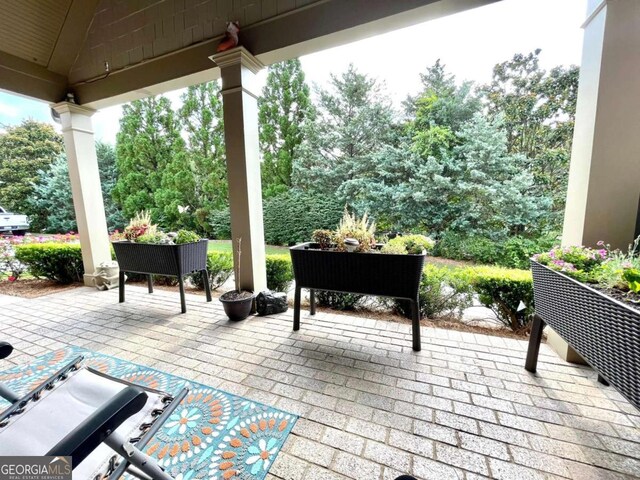 4140 Lanier Ridge Walk Unit 104, Cumming, GA 30041 - view of patio featuring view of wooded area