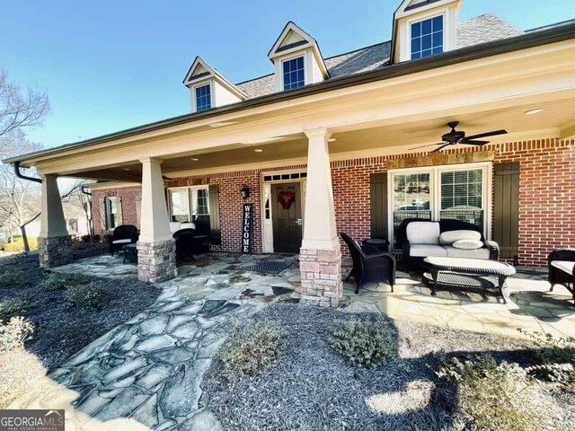 view of front of property with a patio, an outdoor hangout area, and ceiling fan