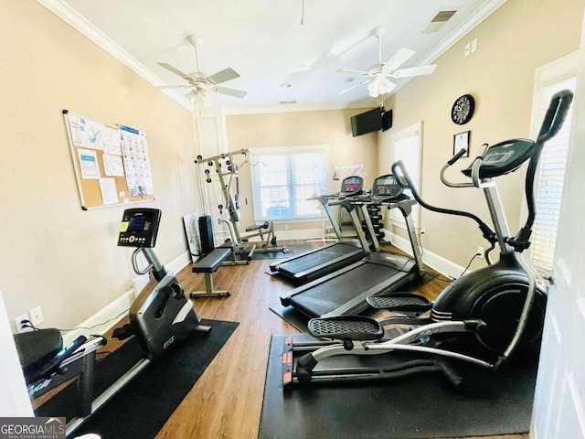 gym with hardwood / wood-style floors, ornamental molding, and ceiling fan