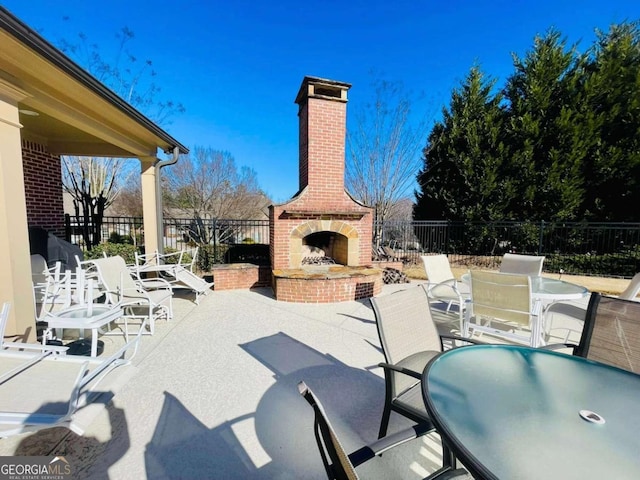 view of patio featuring an outdoor brick fireplace