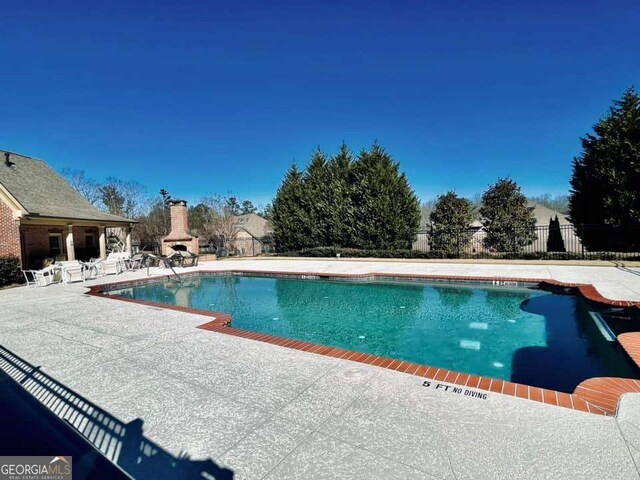 4140 Lanier Ridge Walk Unit 104, Cumming, GA 30041 - view of swimming pool with a patio area and a fireplace