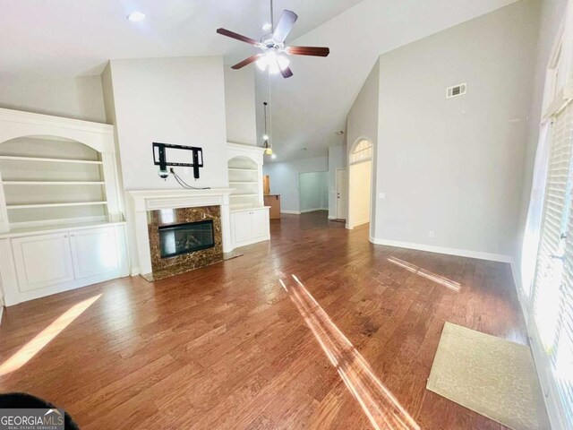 4140 Lanier Ridge Walk Unit 104, Cumming, GA 30041 - unfurnished living room featuring built in features, a ceiling fan, a high end fireplace, high vaulted ceiling, and wood finished floors