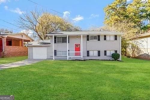 bi-level home with a front lawn and a garage