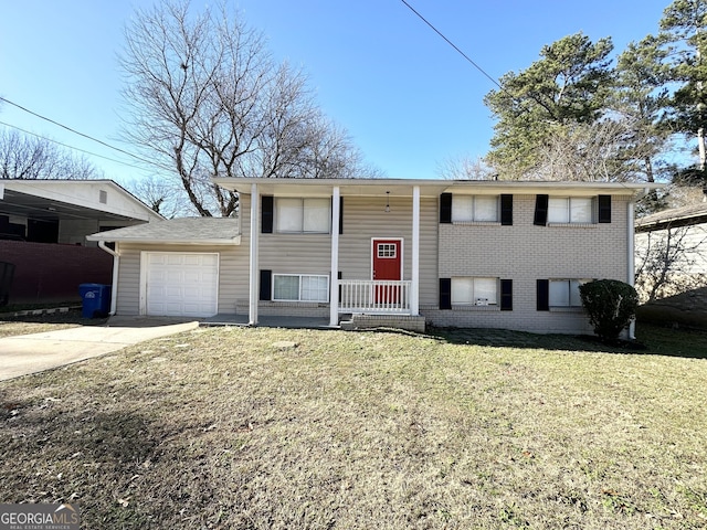 split foyer home with a front yard and a garage