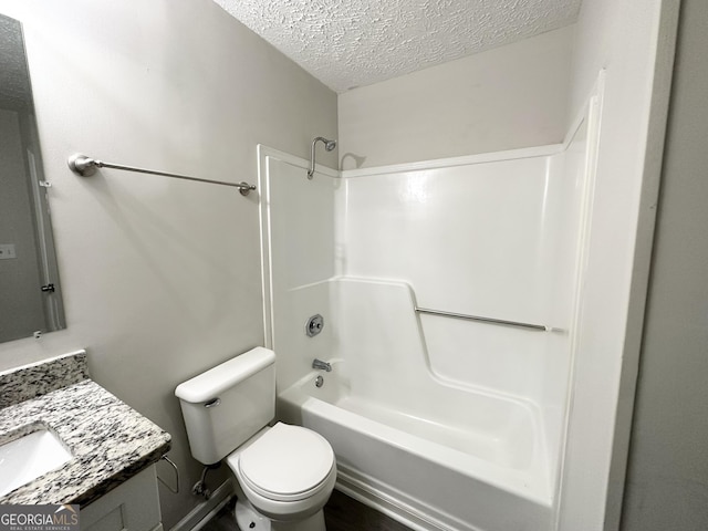 full bathroom with shower / tub combination, vanity, a textured ceiling, and toilet