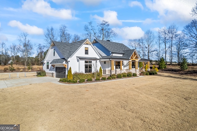 view of front of house with a front lawn, a porch, and a garage