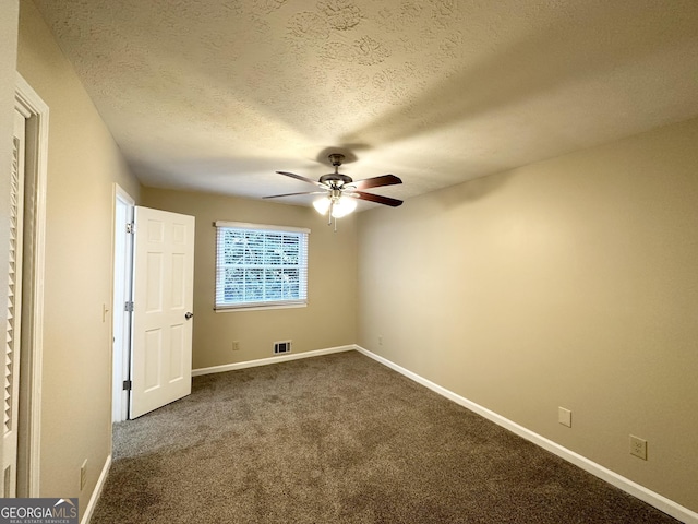 unfurnished bedroom featuring ceiling fan, carpet, and a textured ceiling