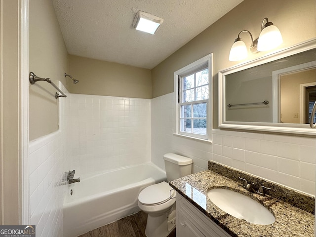 full bathroom with backsplash, a textured ceiling, hardwood / wood-style flooring, tile walls, and toilet