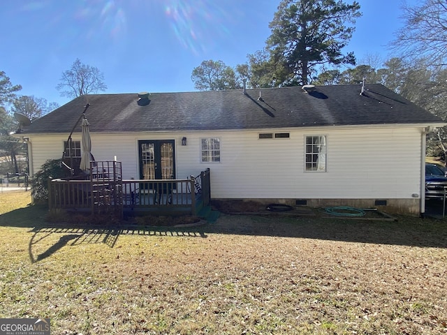 back of house with a wooden deck, french doors, and a lawn