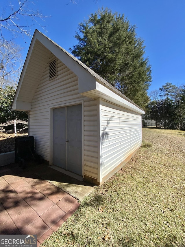 view of outbuilding featuring a yard and a garage