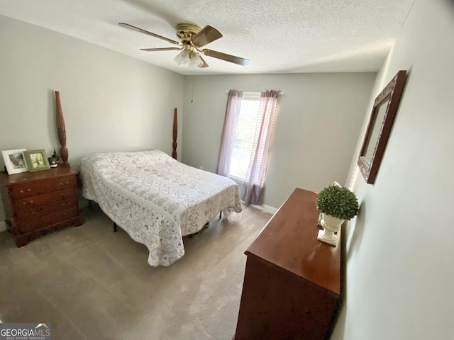 carpeted bedroom with a textured ceiling and ceiling fan