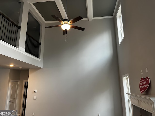 interior space with a high ceiling and ceiling fan