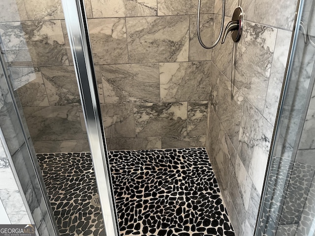 bathroom featuring a shower with shower door