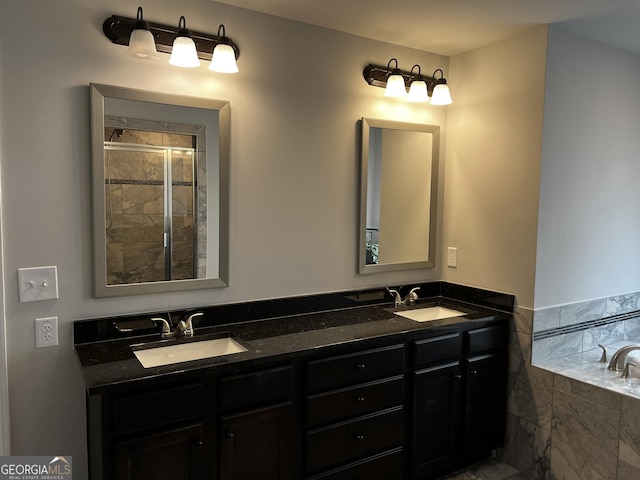 bathroom featuring vanity and tiled tub