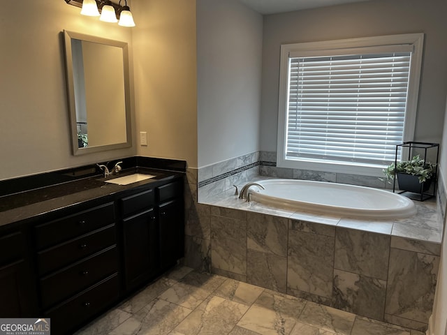 bathroom featuring vanity and a relaxing tiled tub