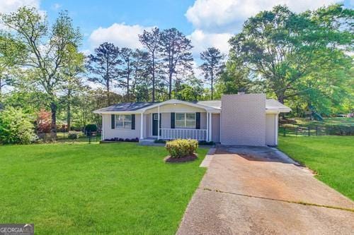 ranch-style house with a front yard, a porch, and a garage