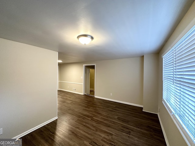 empty room featuring dark wood-type flooring