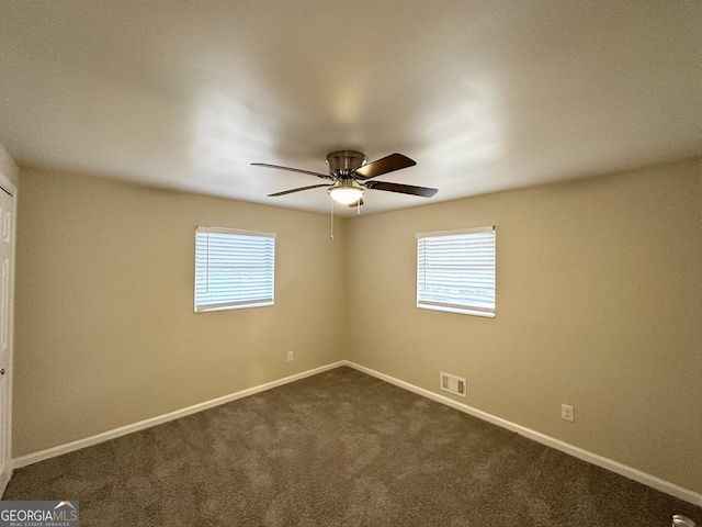 carpeted spare room with ceiling fan