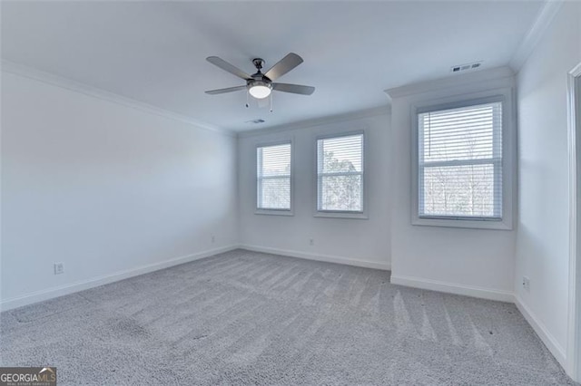 carpeted empty room featuring ceiling fan and ornamental molding