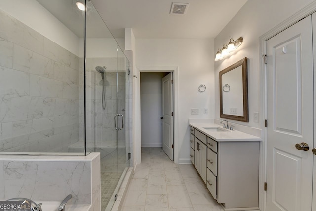 bathroom featuring vanity and a shower with door