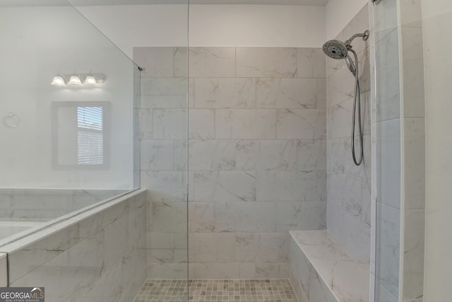 bathroom featuring tiled shower