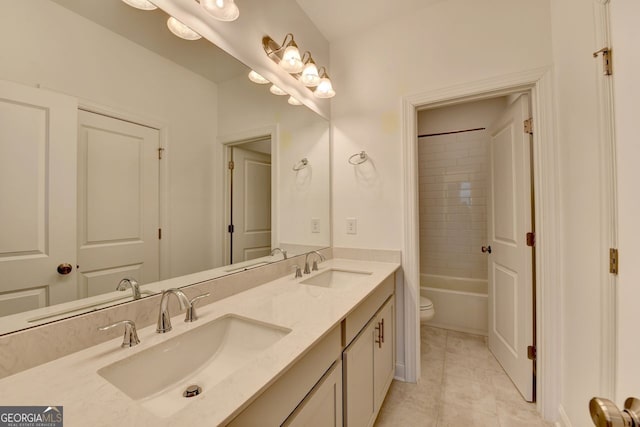 full bathroom with tile patterned flooring, toilet, vanity, and tiled shower / bath