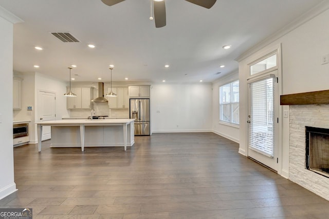 living room with dark hardwood / wood-style flooring, ceiling fan, a fireplace, and crown molding