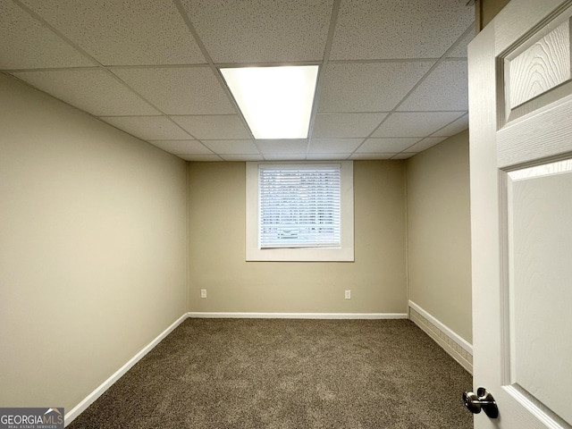 carpeted empty room with a drop ceiling